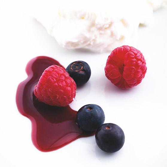 Yoghurt dessert with red wine coulis and berries